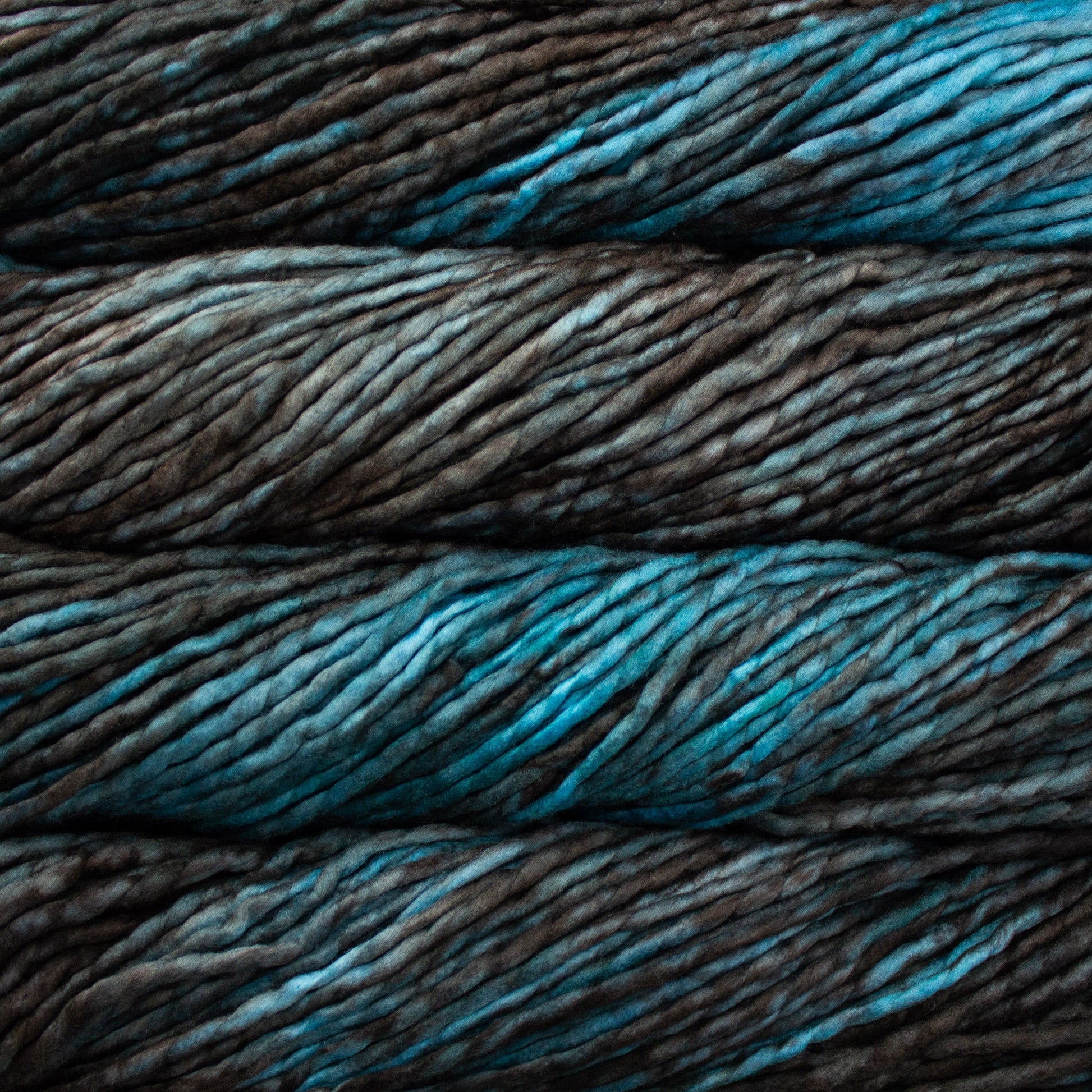 A close-up image of skeins of Malabrigo Rasta yarn in bright blue and ash brown, displaying the texture and color variation.