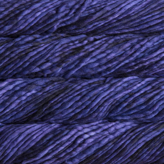 A close-up image of skeins of Malabrigo Rasta yarn in dark purple shades, displaying the texture and color variation.