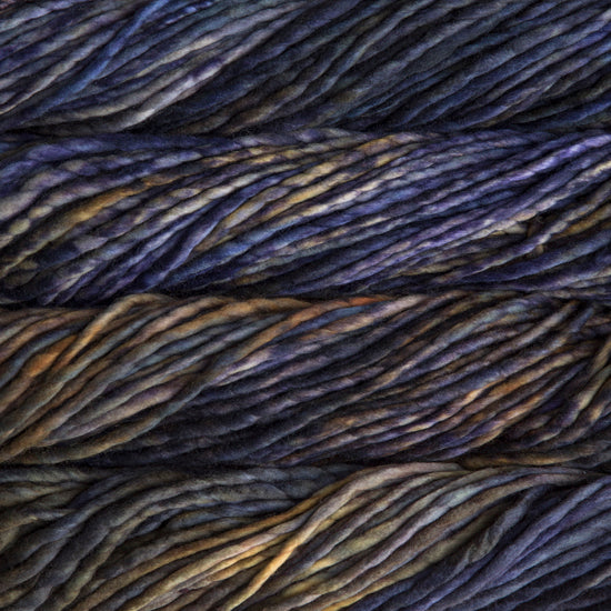 A close-up image of skeins of Malabrigo Rasta yarn in shades of brown, purple and yellow, displaying the texture and color variation.