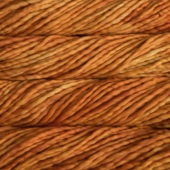 A close-up image of skeins of Malabrigo Rasta yarn in a bright yellow orange, displaying the texture and color variation.