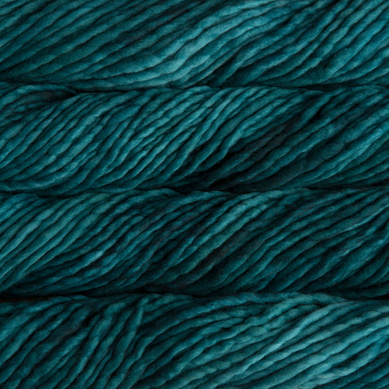 A close-up image of skeins of Malabrigo Rasta yarn in shades of teal, displaying the texture and color variation.