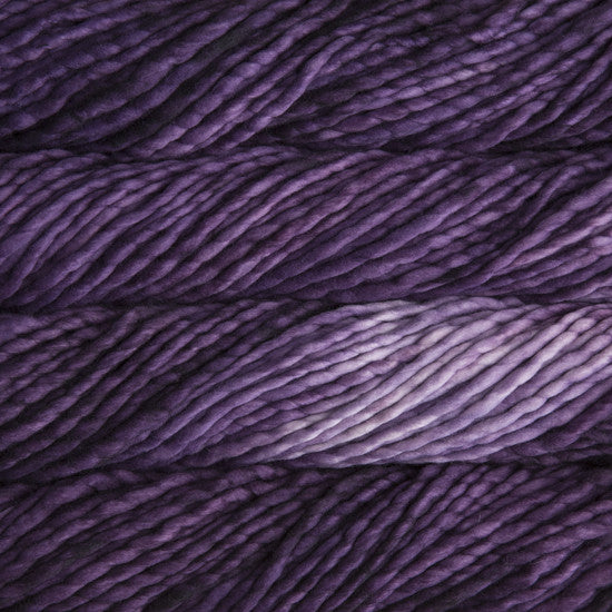 A close-up image of skeins of Malabrigo Rasta yarn in shades of purple and violet, displaying the texture and color variation.