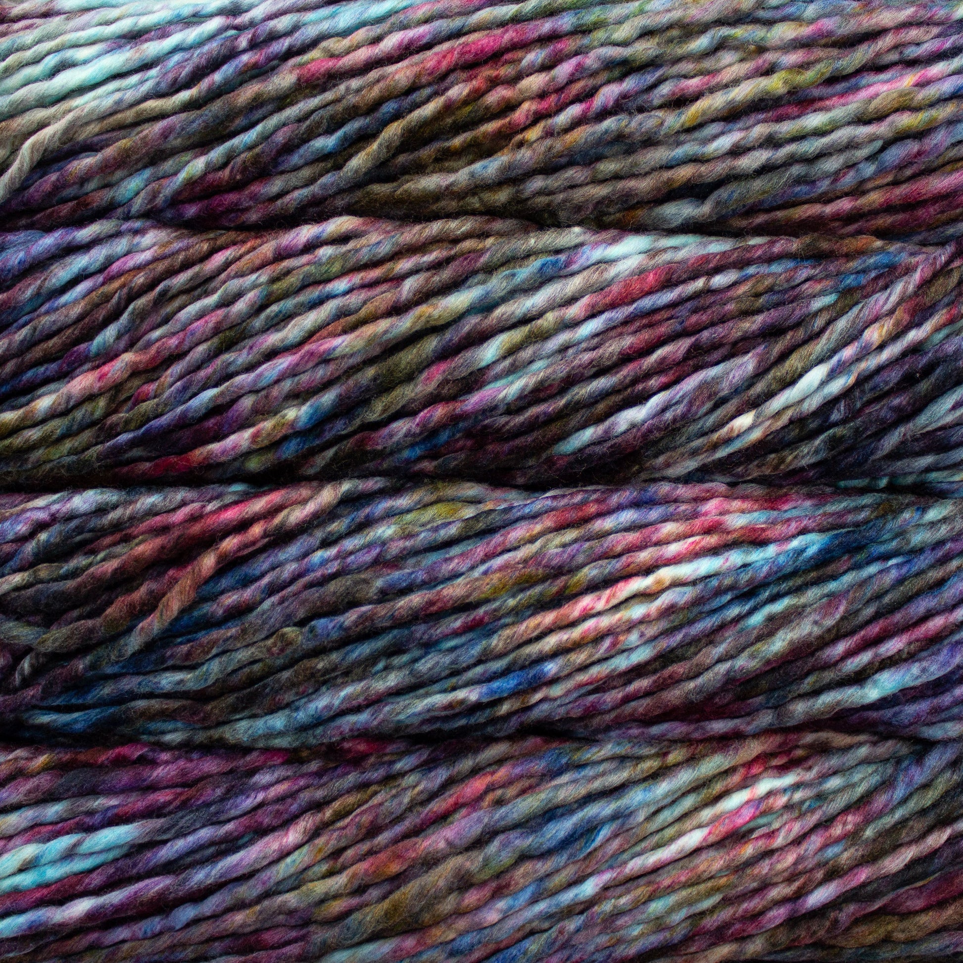 A close-up image of skeins of Malabrigo Rasta yarn in a rainbow of colors, displaying the texture and color variation.