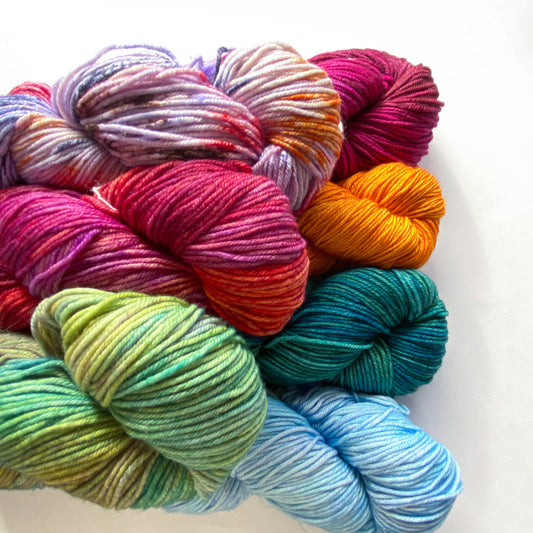 Pile of colorful Malabrigo Rios skeins of yarn on a white background