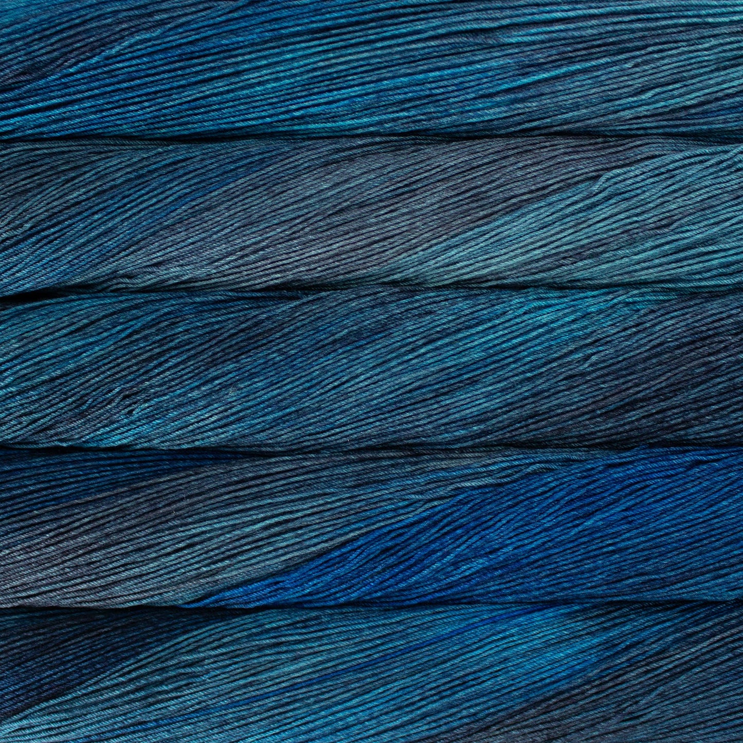 Close up of several skeins of yarn in shades of blue