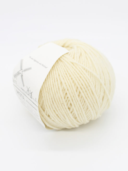 A skein of natural wool yarn with a label, on a white background.